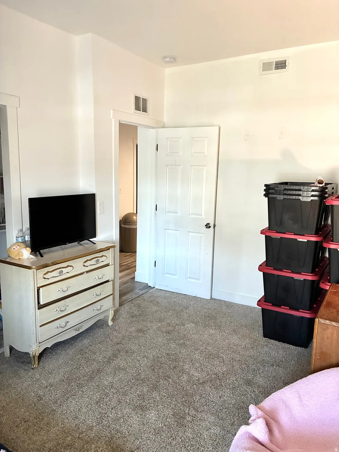 Bedroom featuring carpet and baseboards