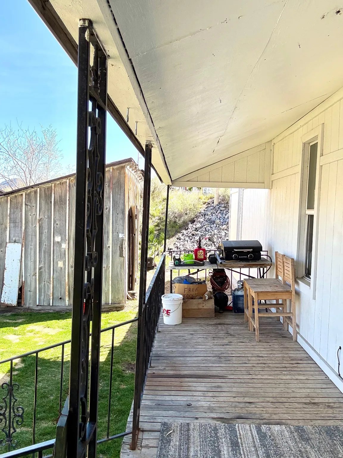 Deck with a lawn and a grill