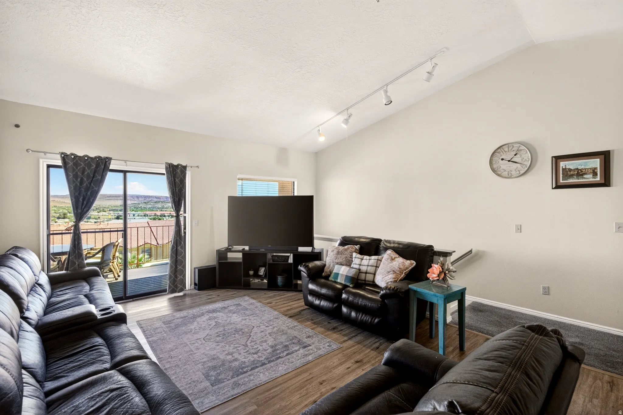 Living area featuring track lighting and wood finished floors