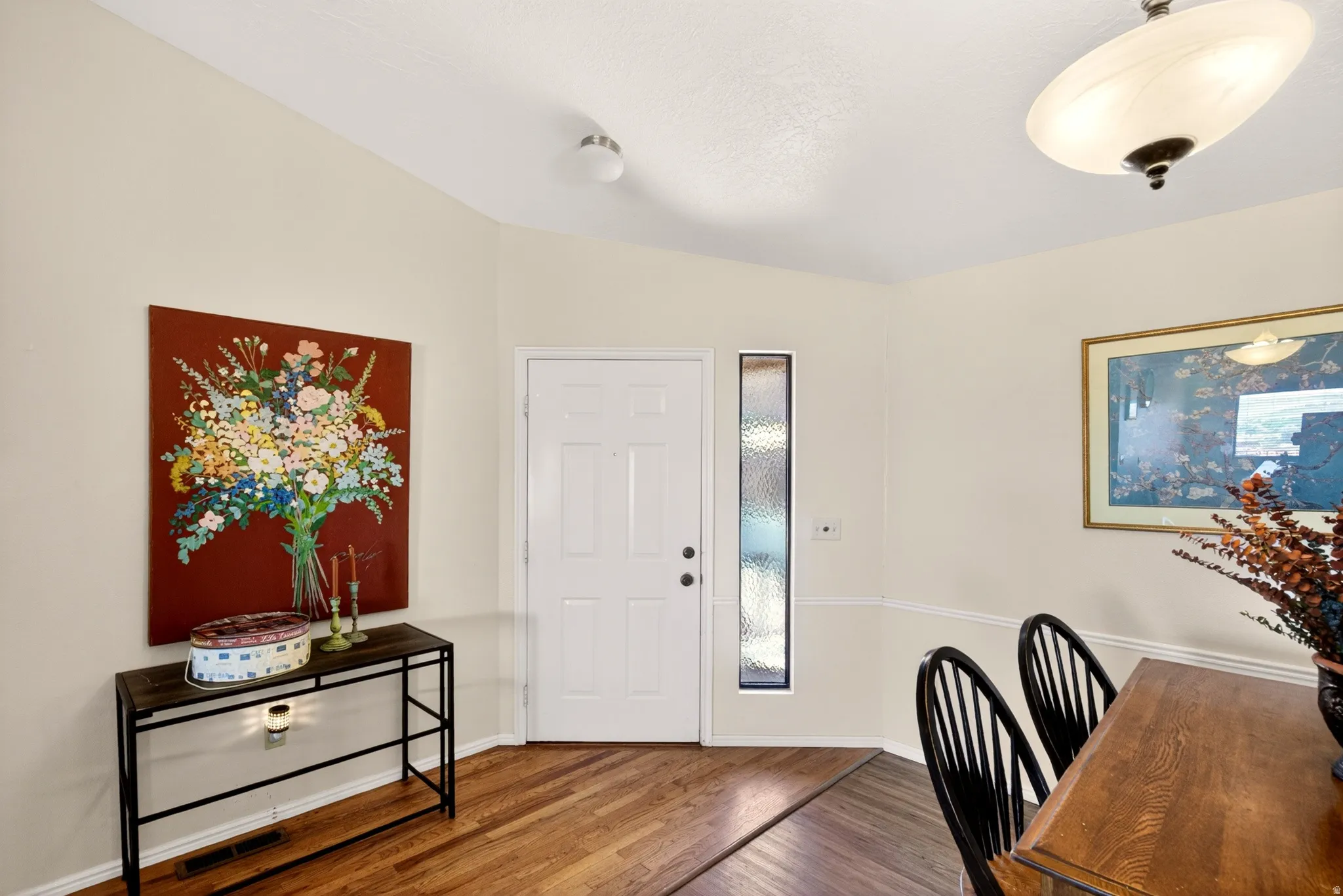Entrance foyer with wood finished floors and baseboards