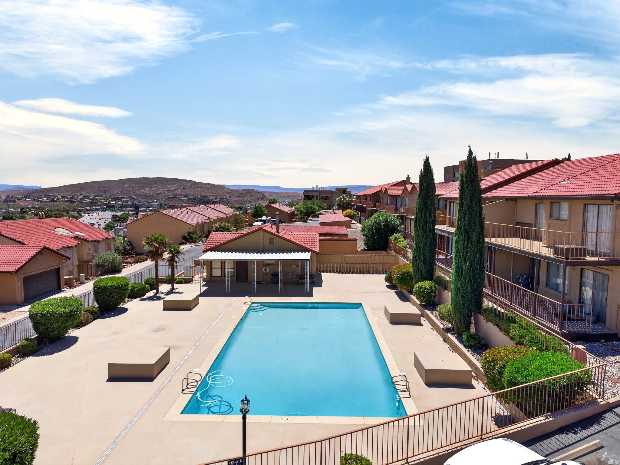 Community pool with a patio area, a residential view, and a mountain view