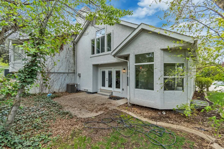 Rear view of property featuring french doors and stucco siding