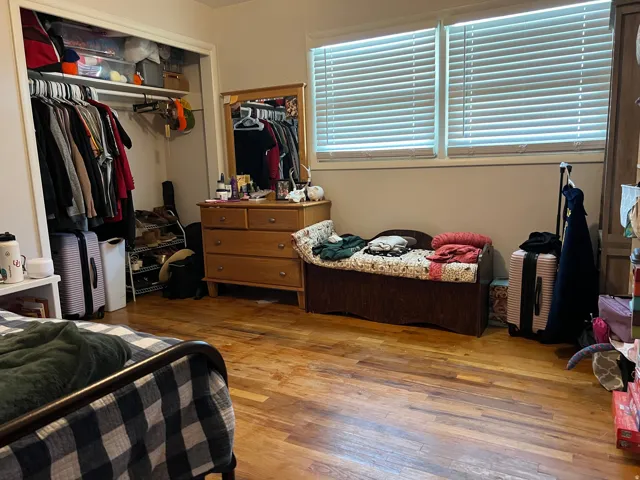 Bedroom featuring light wood-type flooring and a closet