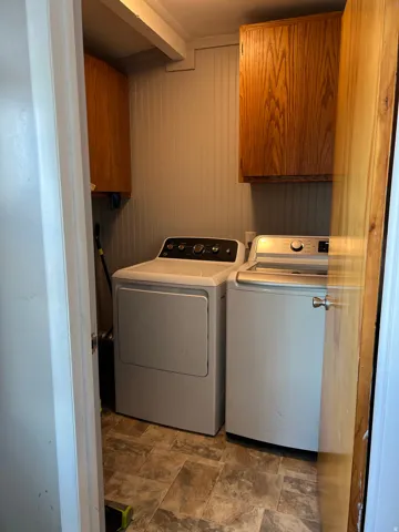 Laundry room with cabinet space and washer and dryer