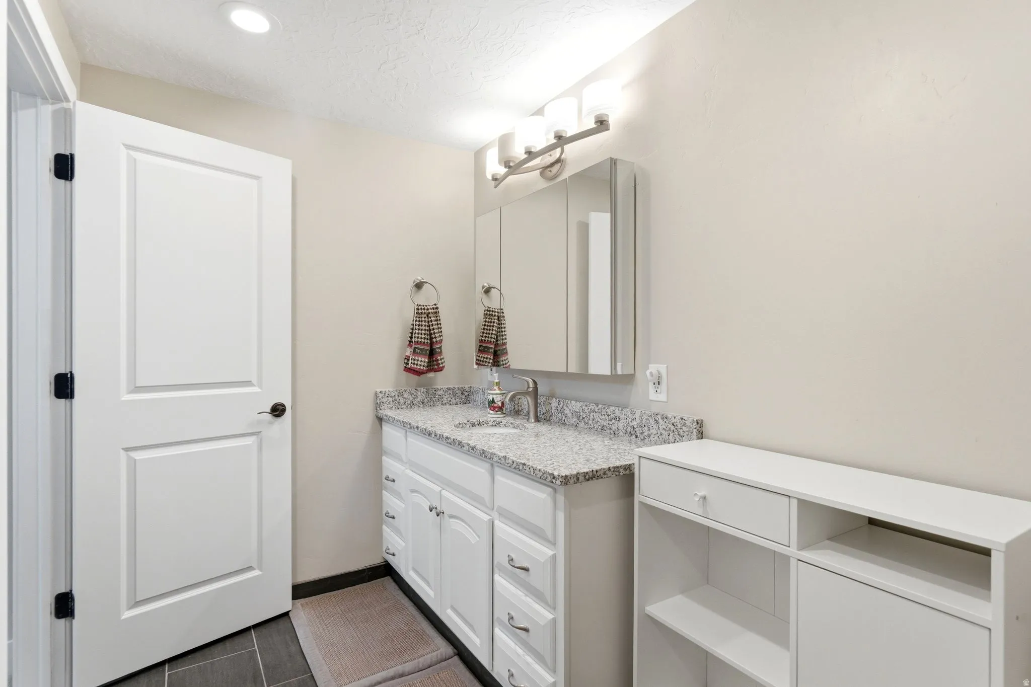 Bathroom featuring vanity and a textured ceiling