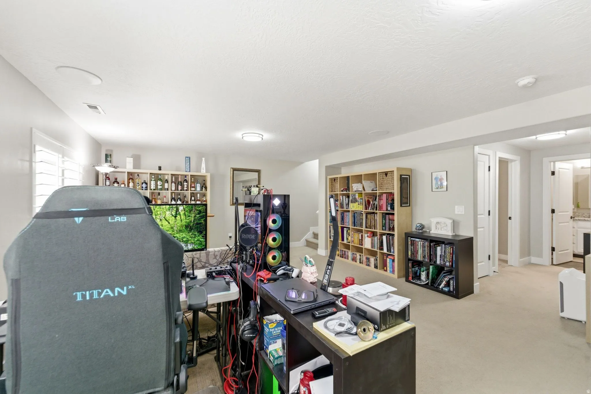 Office space featuring light carpet and baseboards