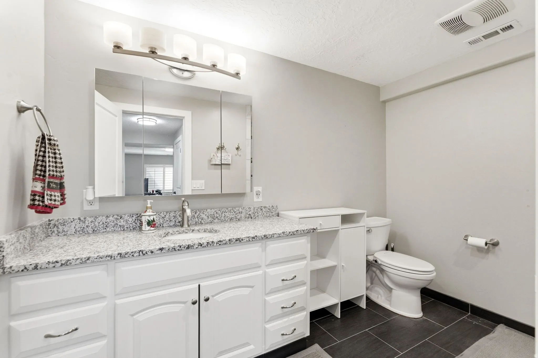 Bathroom featuring vanity and a textured ceiling