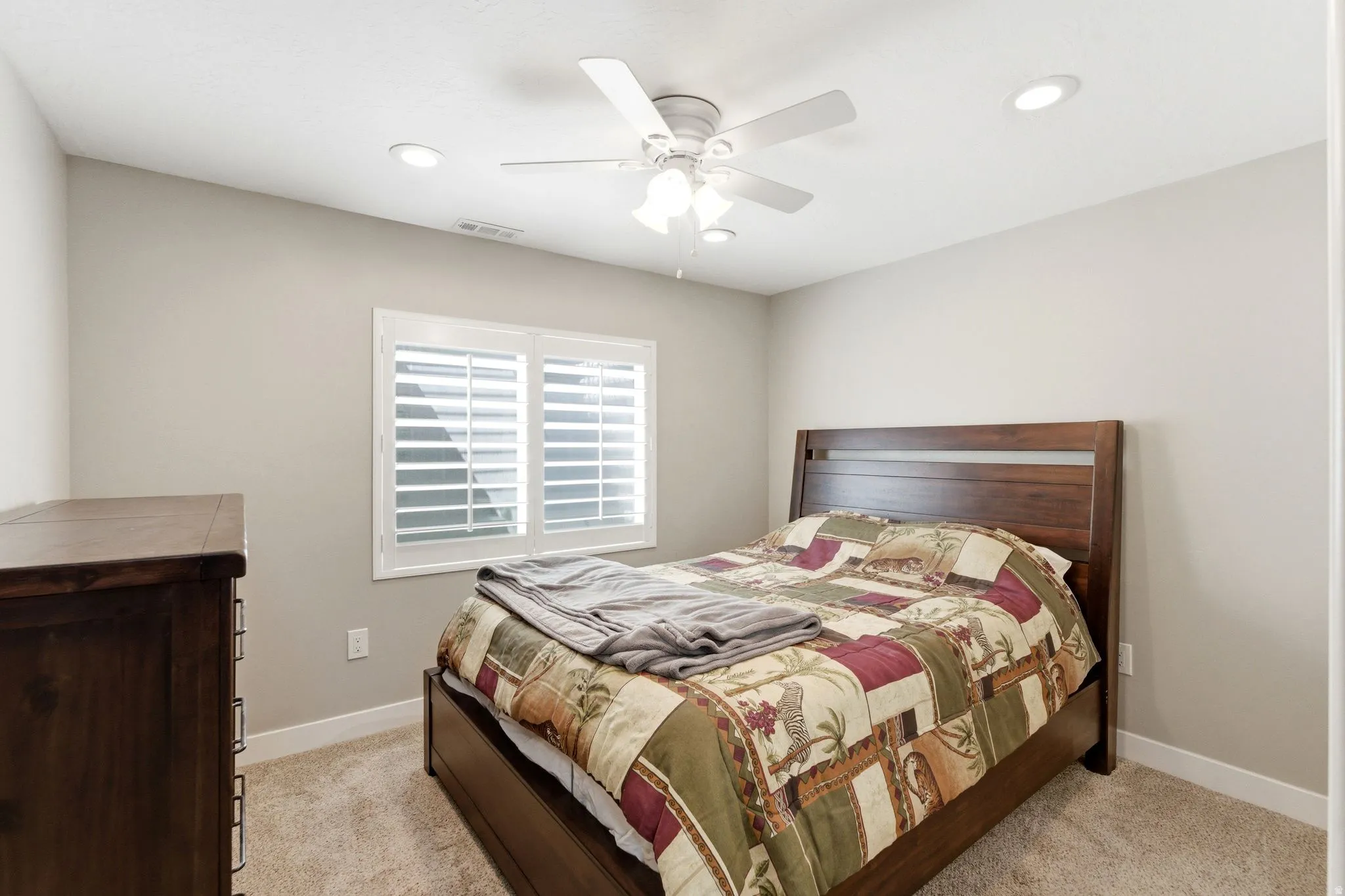 Bedroom featuring ceiling fan, recessed lighting, and light carpet