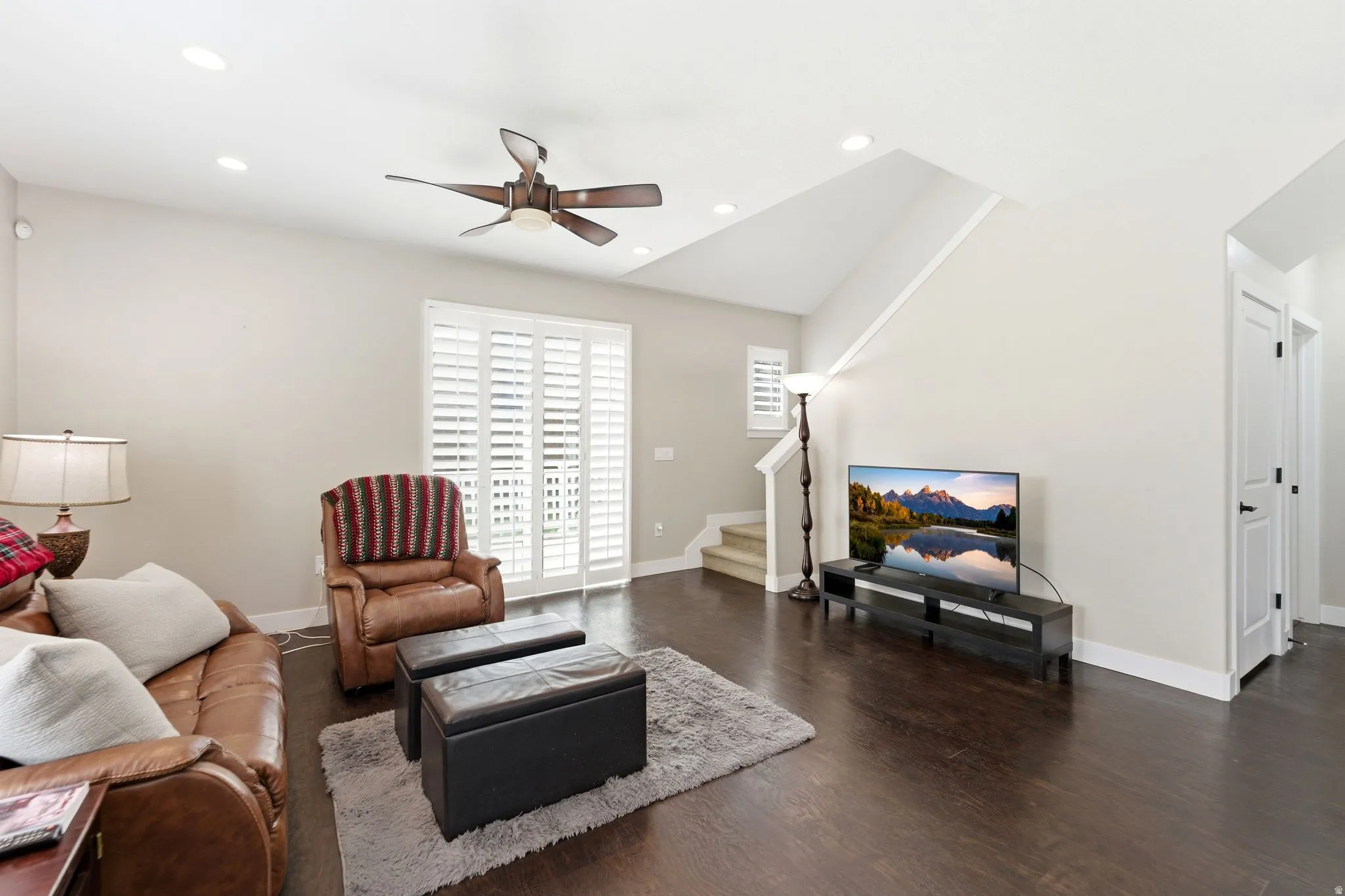 Living area with wood finished floors, ceiling fan, and recessed lighting