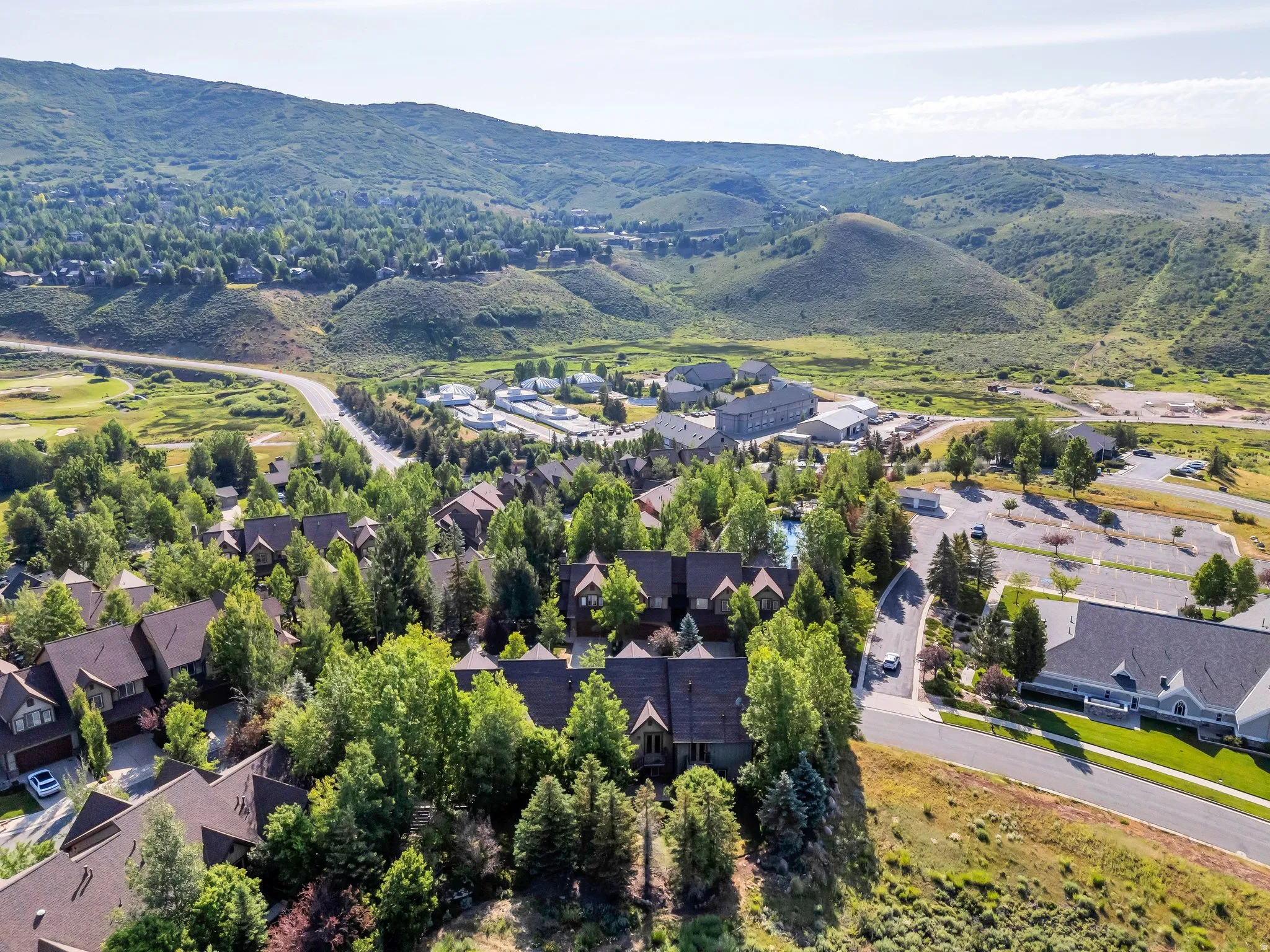 Aerial view of property's location featuring nearby suburban area and mountains