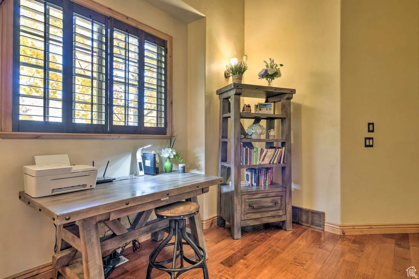 Office space featuring hardwood / wood-style flooring and baseboards