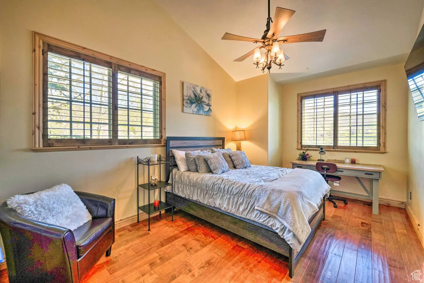 Bedroom with wood-type flooring, vaulted ceiling, and a ceiling fan