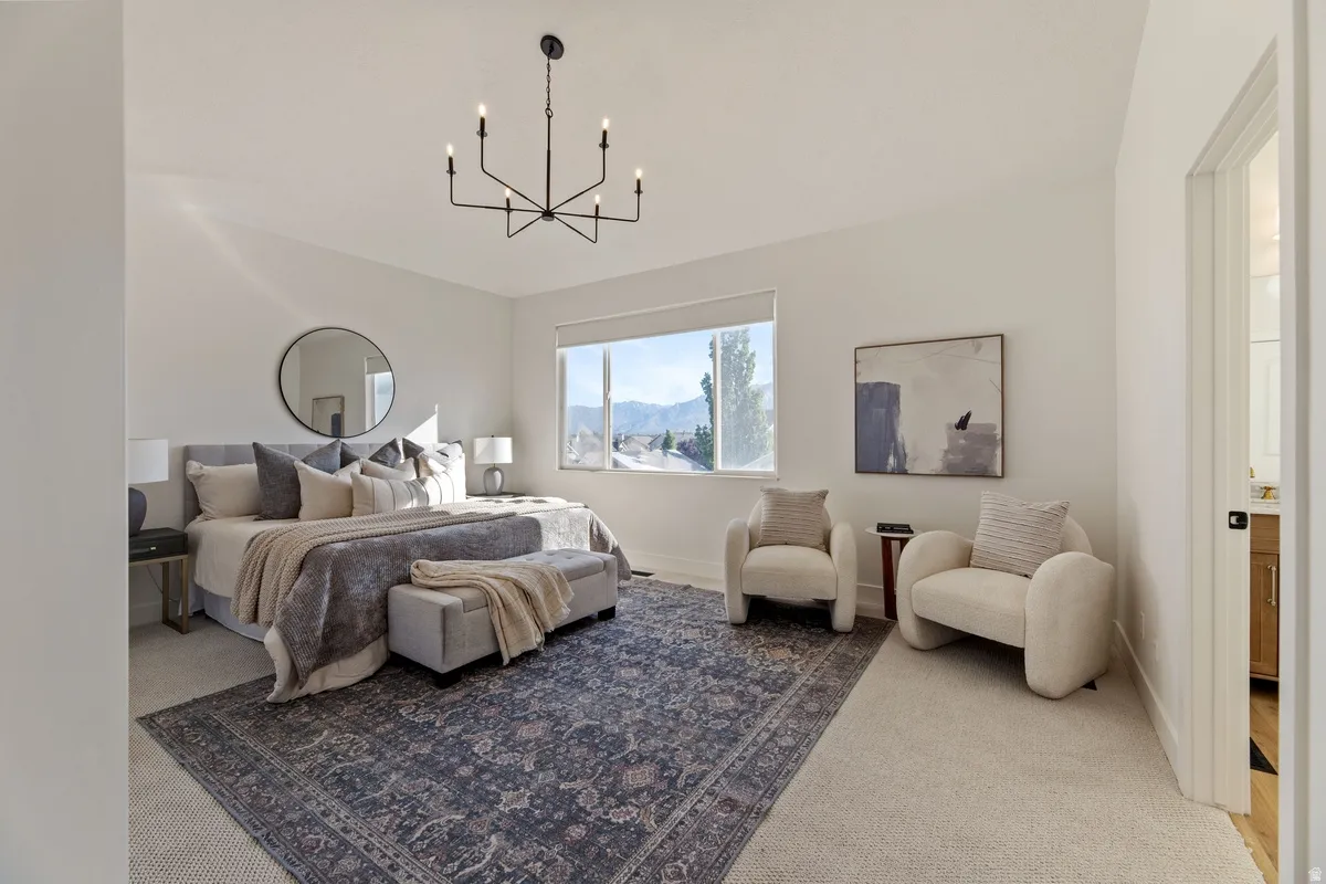 Carpeted bedroom with hanging lights and a mountain view