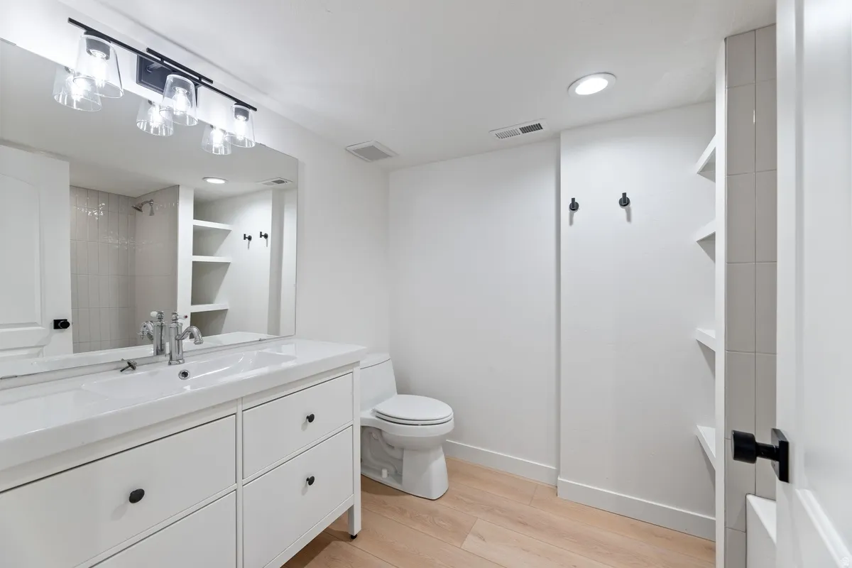 Full bathroom featuring vanity, recessed lighting, and light wood-type flooring