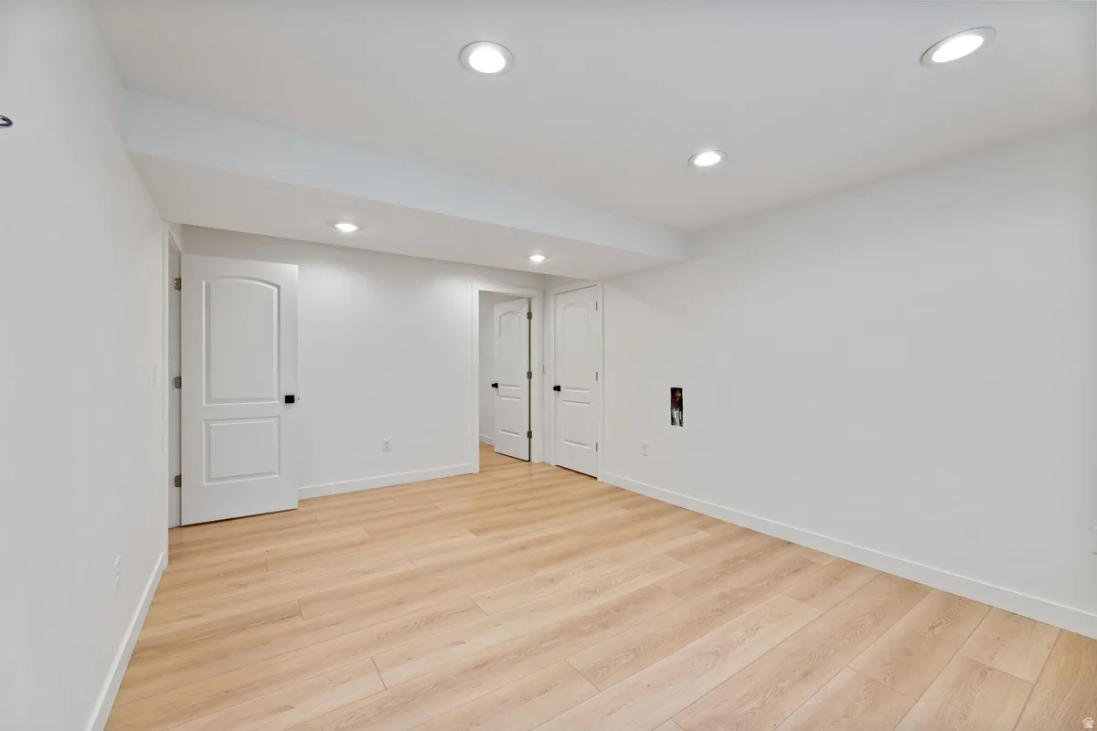 Finished basement with recessed lighting and light wood finished floors