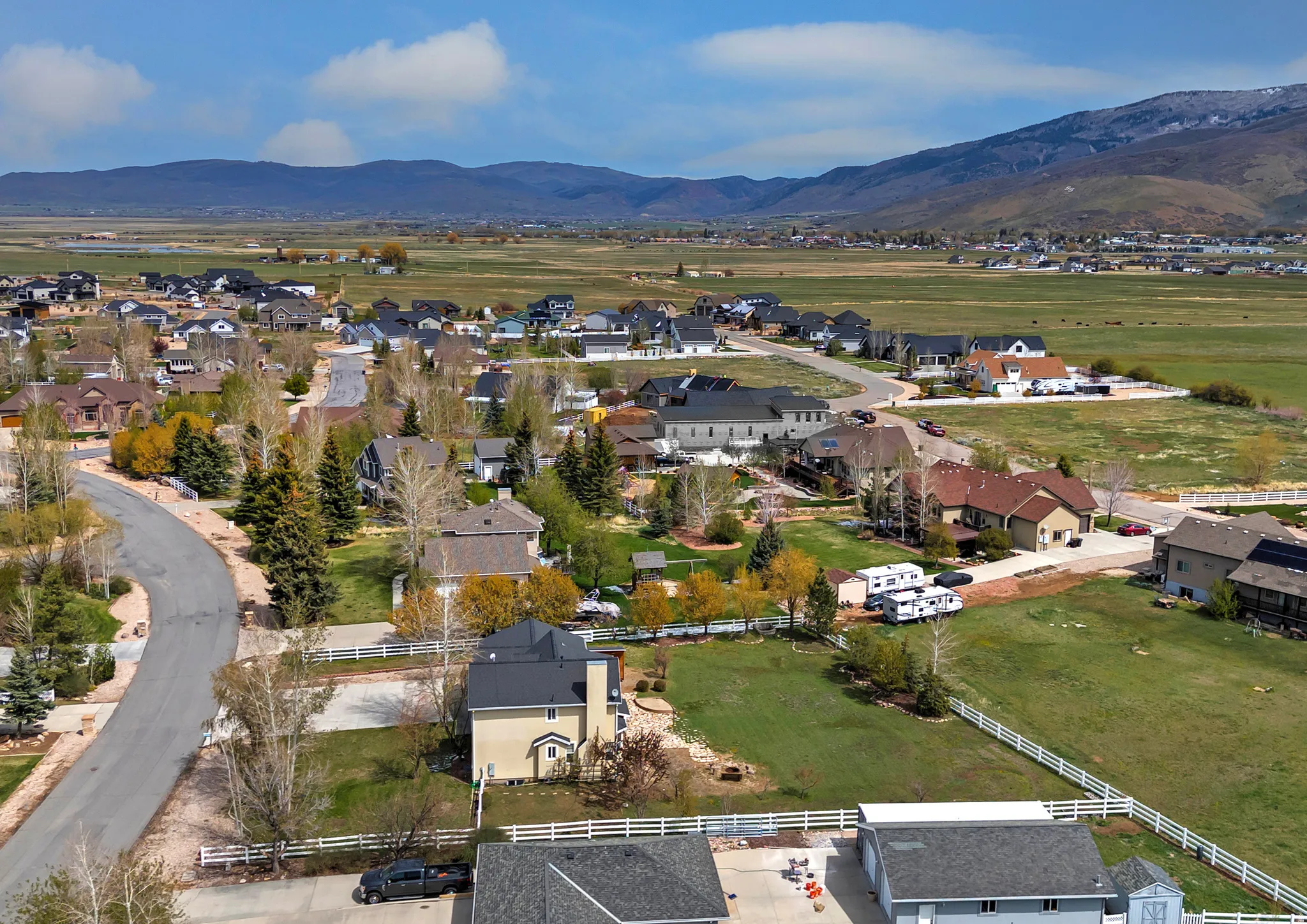 Aerial view of property's location with mountains and nearby suburban area