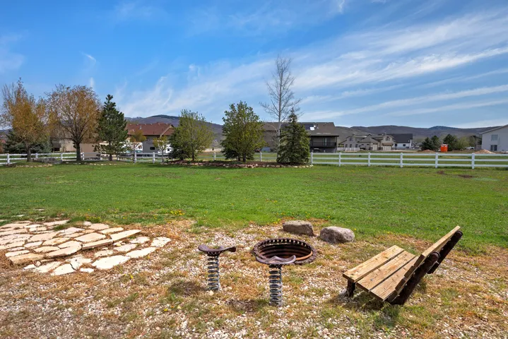 Fenced backyard with a fire pit and a mountain view