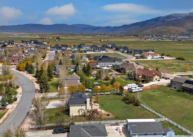 Aerial view of property's location with mountains and nearby suburban area