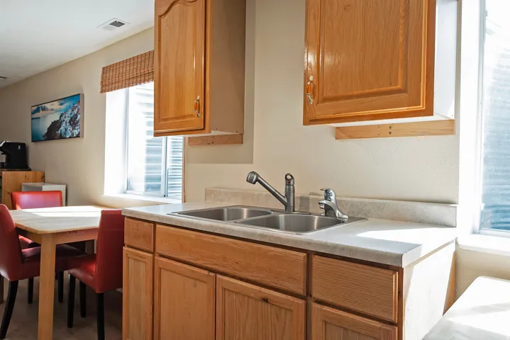 Kitchen with light countertops and wood finish cabinetry