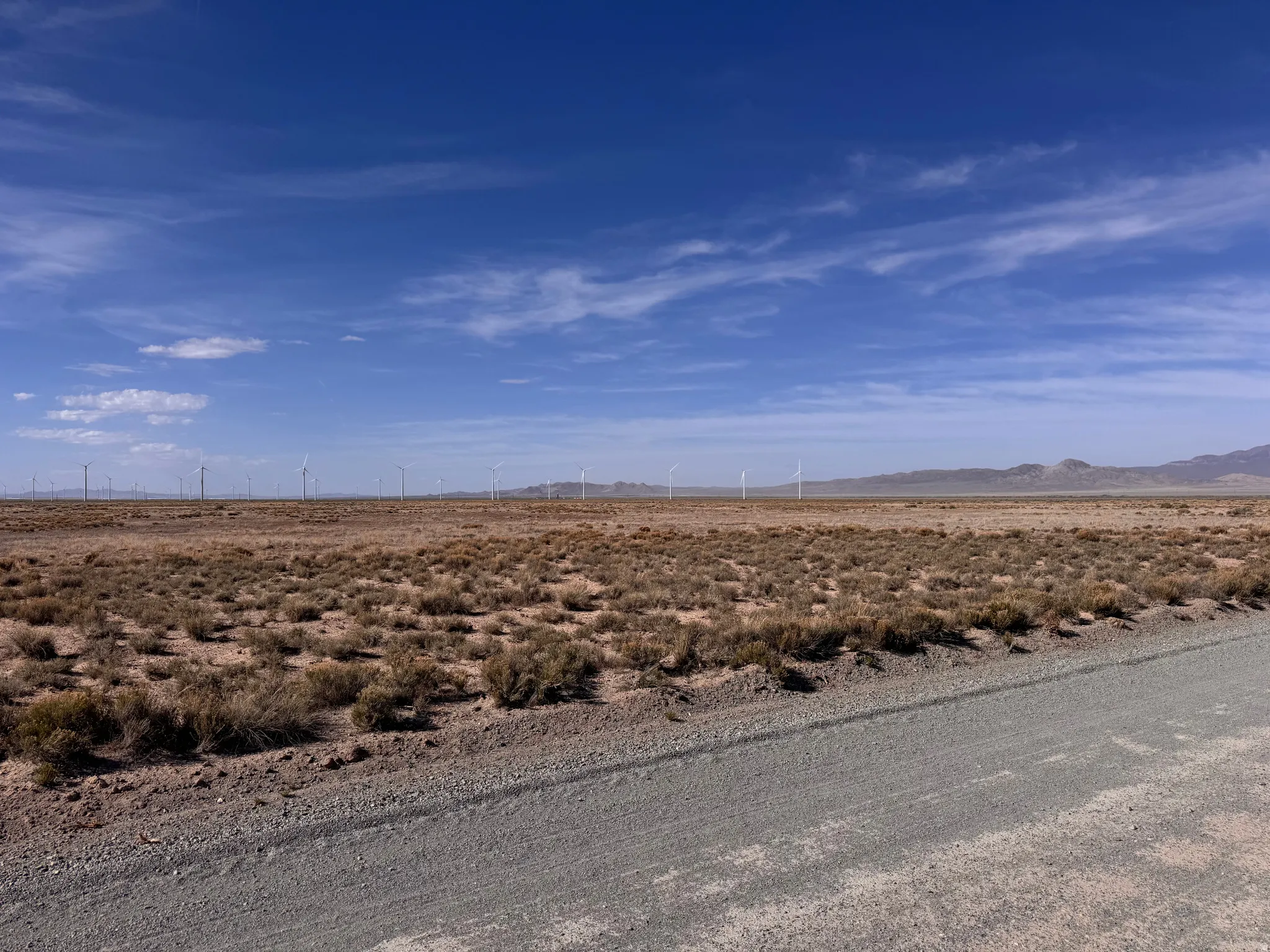 View of road with view of desert, a mountain view, and a view of countryside