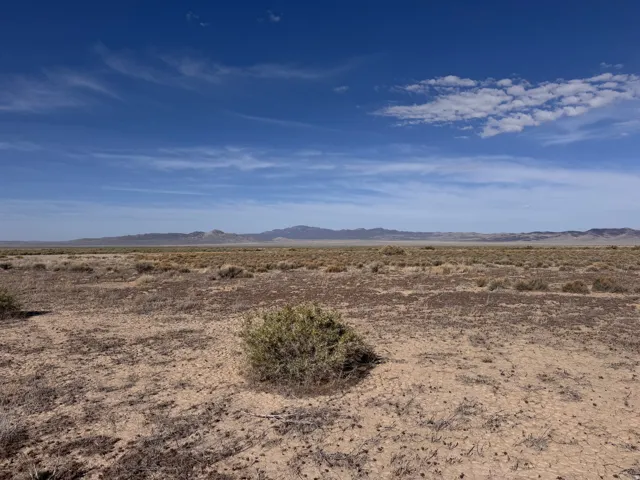 View of mountain backdrop featuring a desert landscape