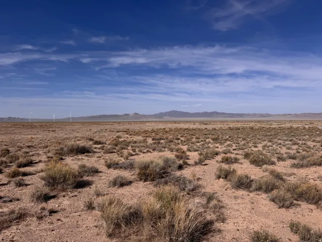 View of mountain backdrop featuring a desert landscape