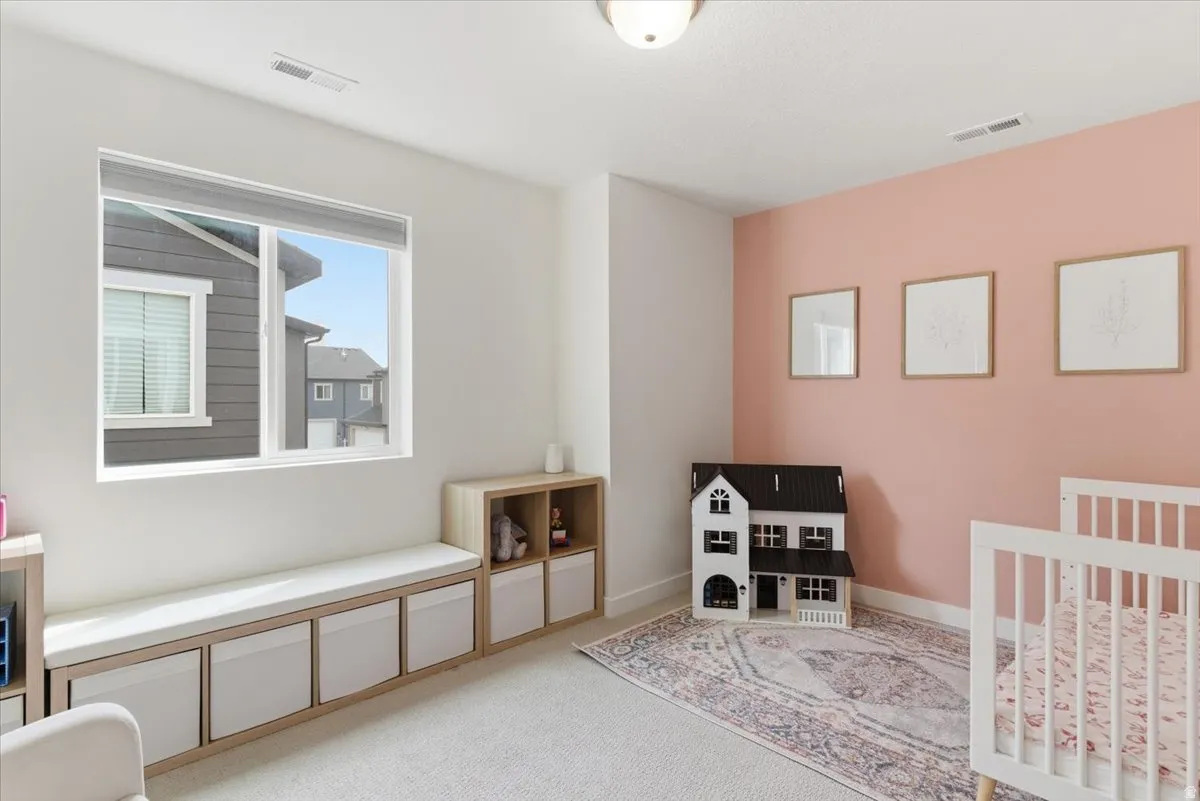 Bedroom with light colored carpet