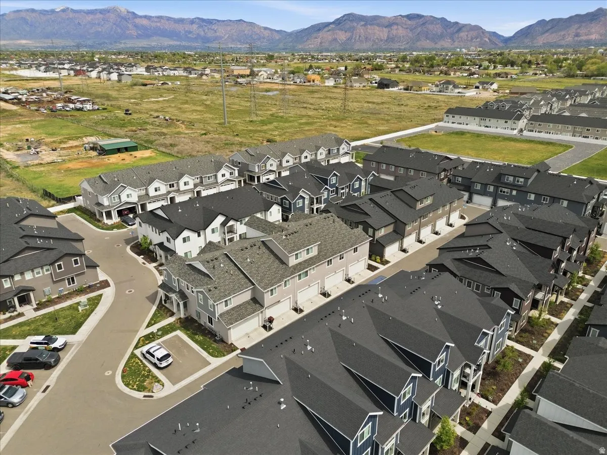 Aerial view of property's location featuring nearby suburban area and mountains