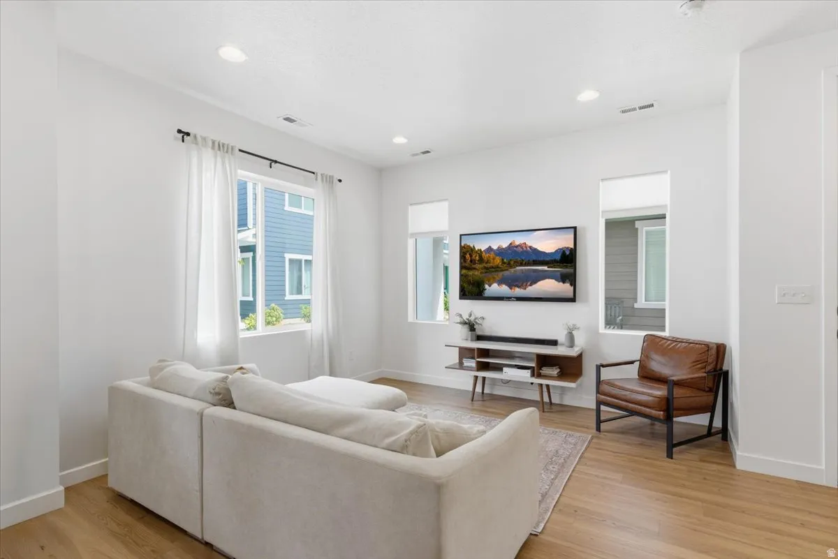 Living room featuring light wood finished floors and recessed lighting