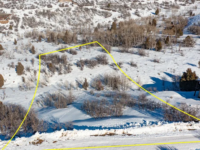Snowy aerial view featuring property boundaries highlighted