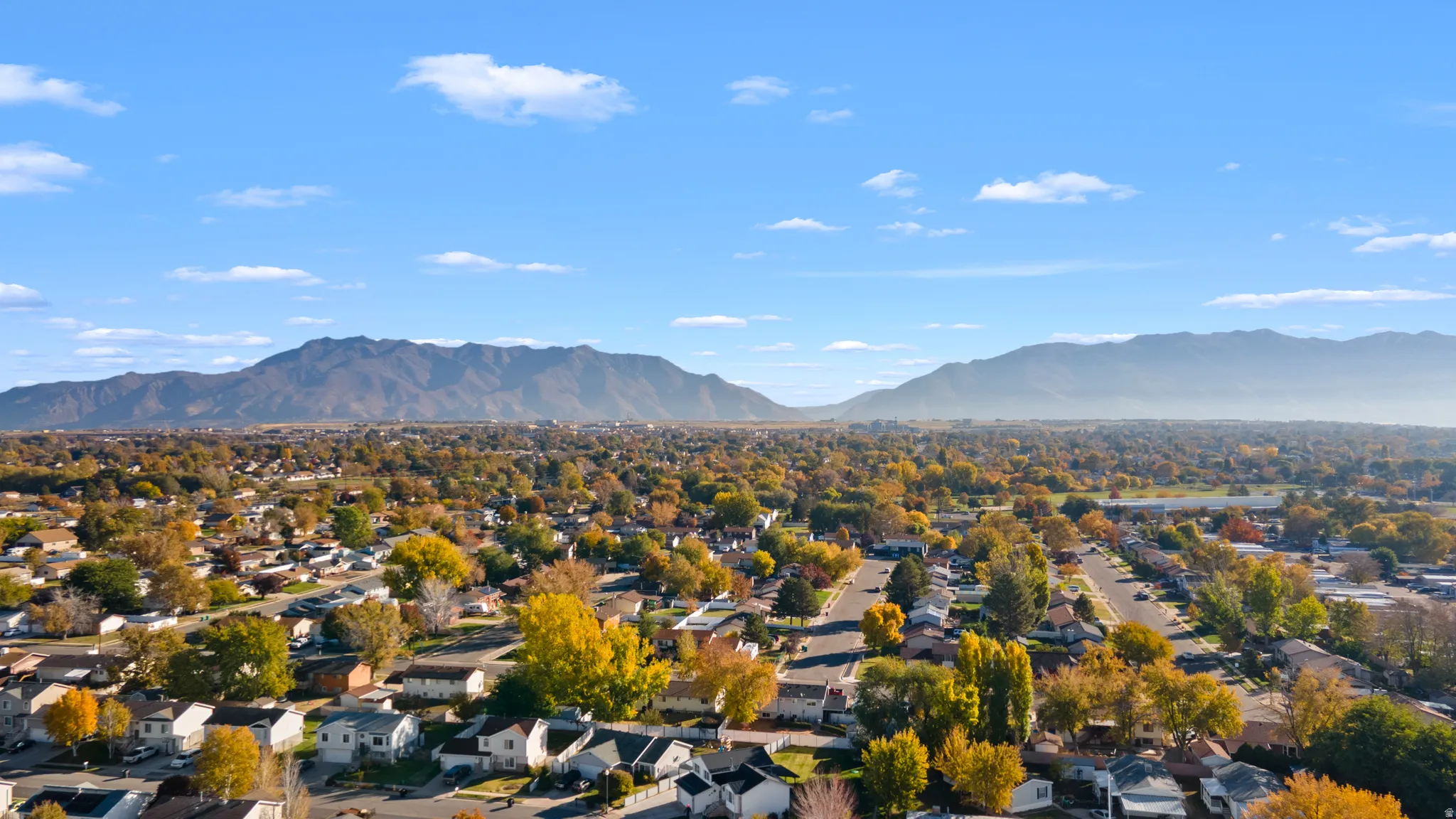 Aerial perspective of suburban area featuring a mountainous background