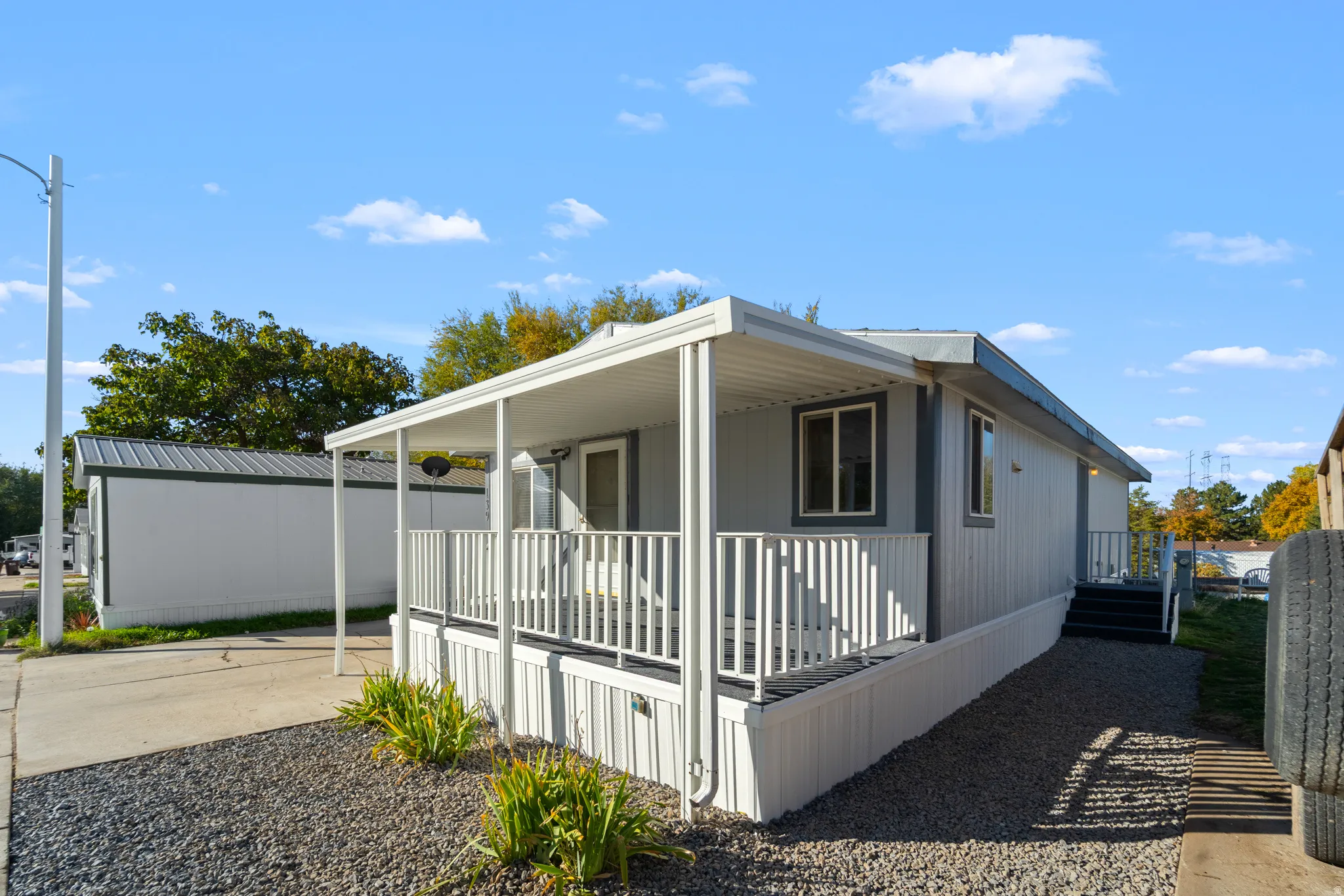 View of side of home with a porch and driveway
