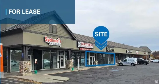 View of commercial property featuring uncovered parking