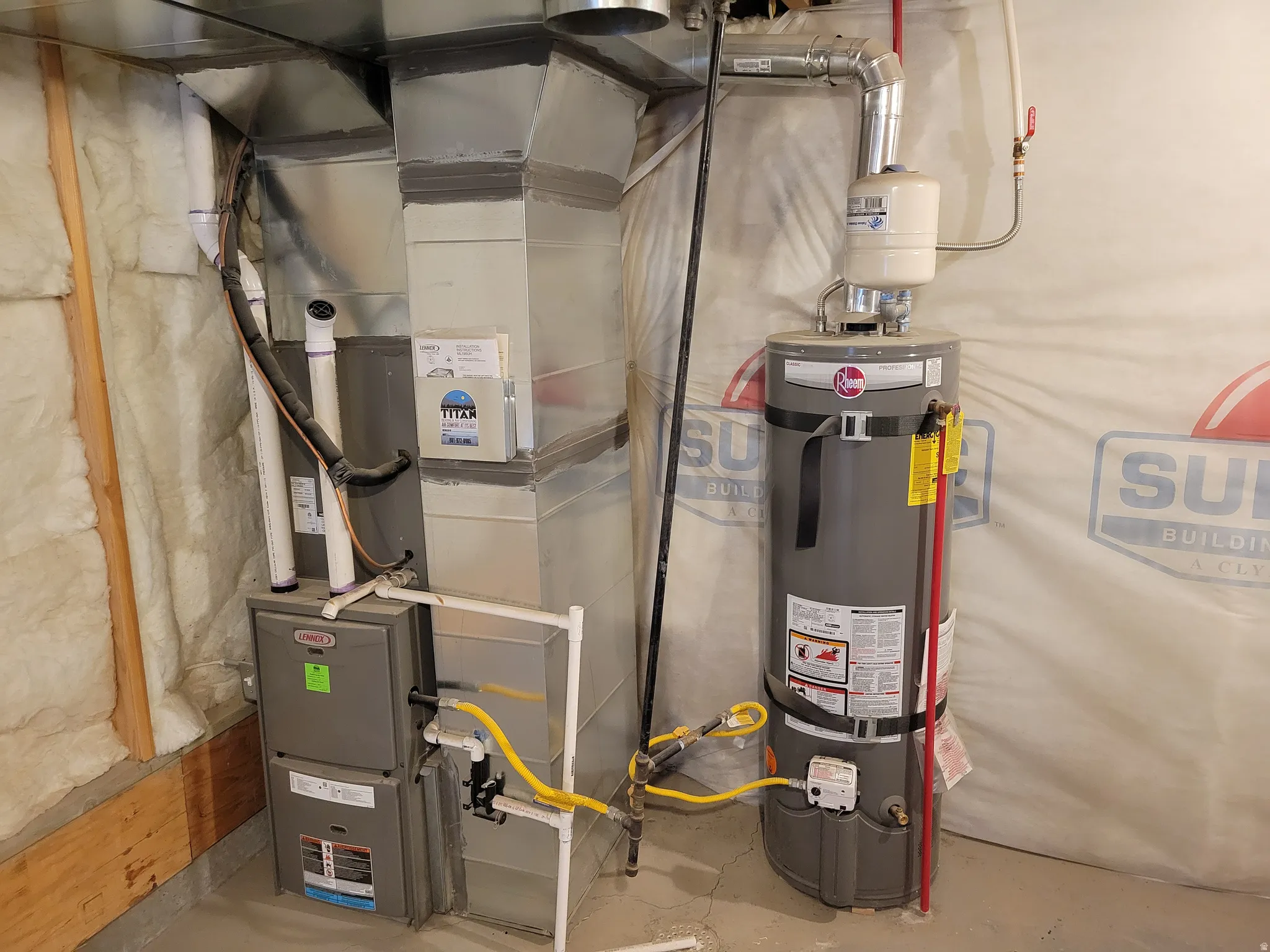 Utility room featuring heating unit and water heater