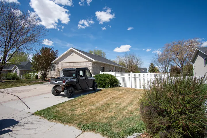 View of home's exterior with brick siding and driveway