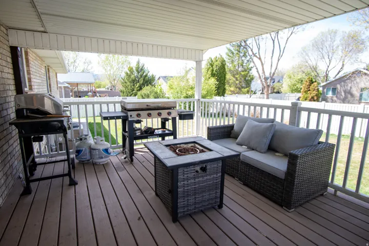 Wooden deck with grilling area and an outdoor living space with a fire pit