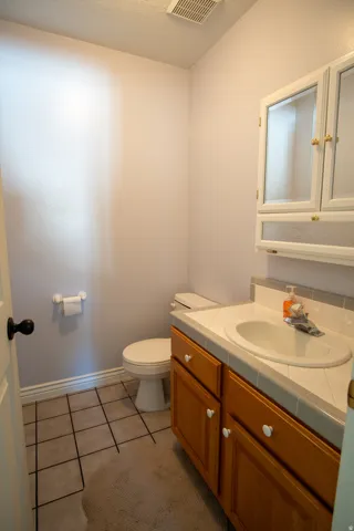 Bathroom with vanity and light tile patterned flooring