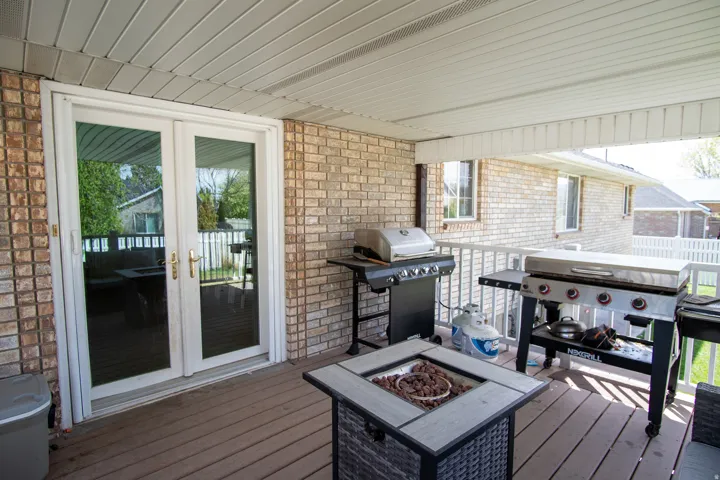Wooden terrace with french doors, a grill, and an outdoor fire pit