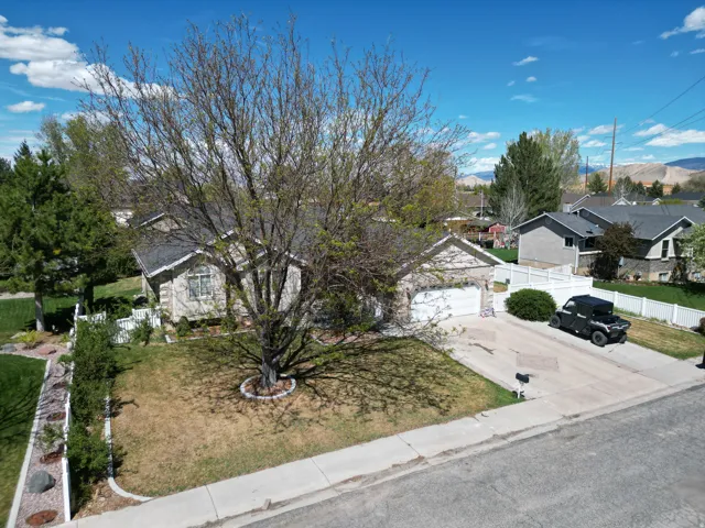 View of front facade with concrete driveway, a garage, and a residential view
