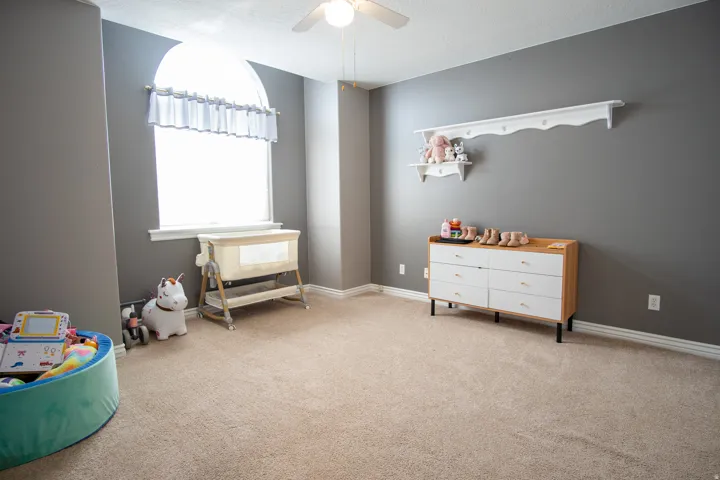 Rec room with ceiling fan, a textured ceiling, and light colored carpet