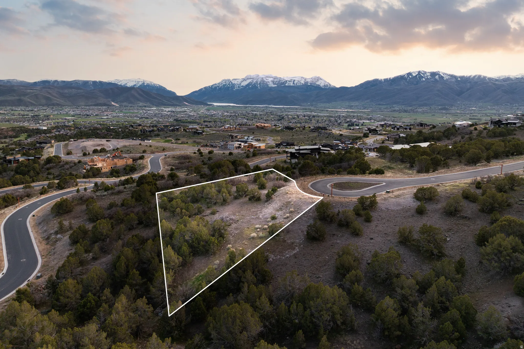 Aerial view at dusk of a mountain view and property boundaries highlighted