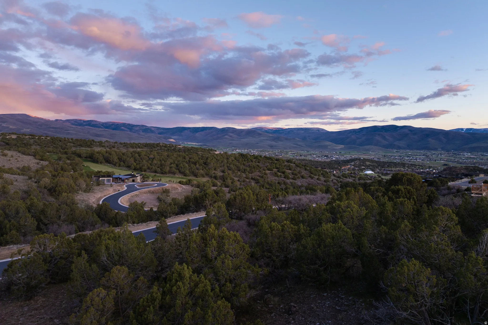 View of mountain backdrop with a heavily wooded area