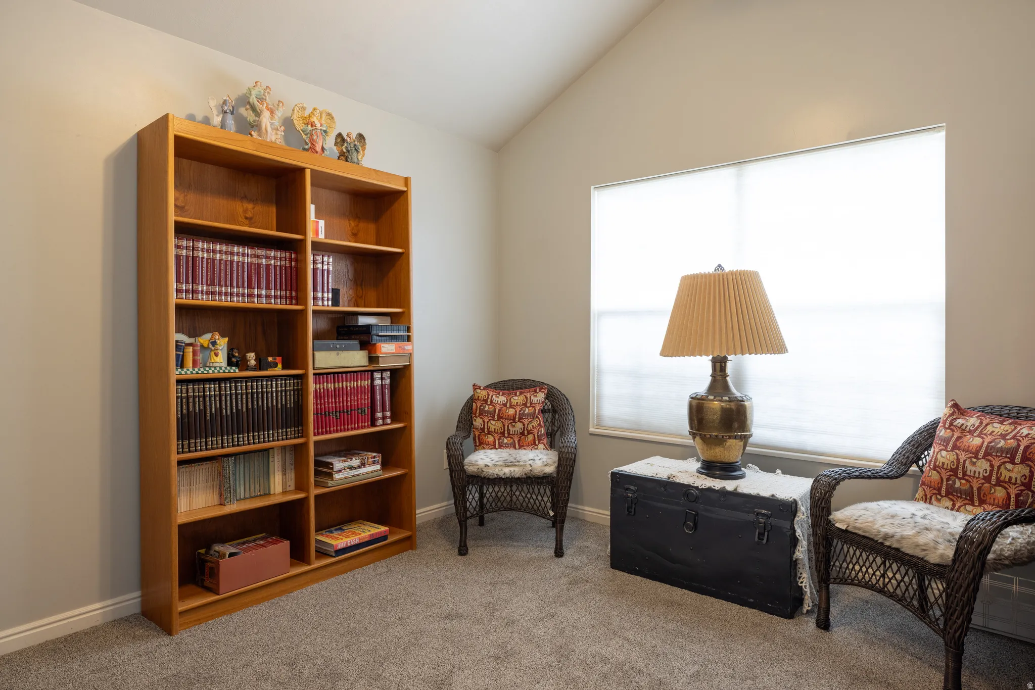 Bedroom 2 with light colored carpet and vaulted ceiling