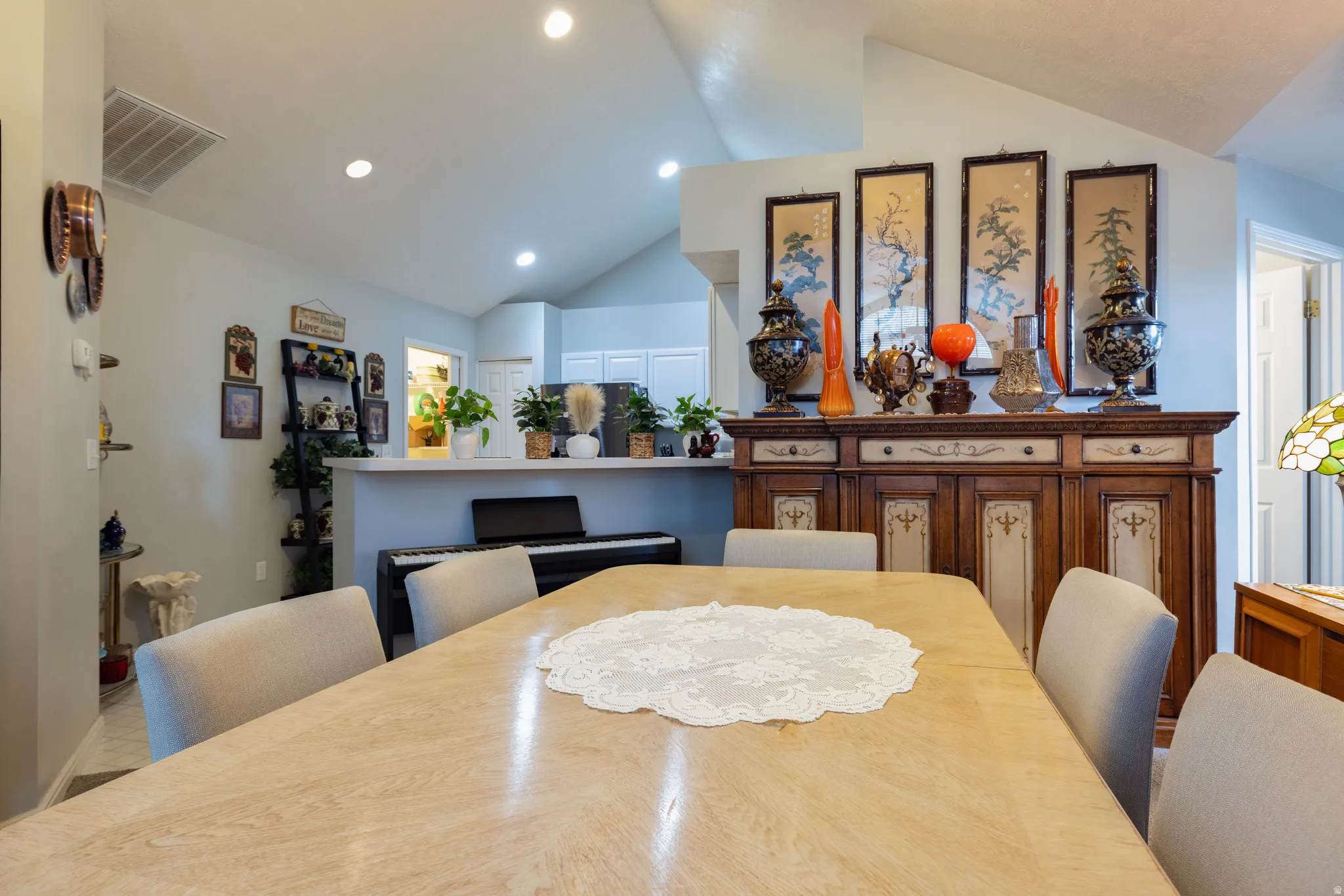 Dining space featuring vaulted ceiling and recessed lighting