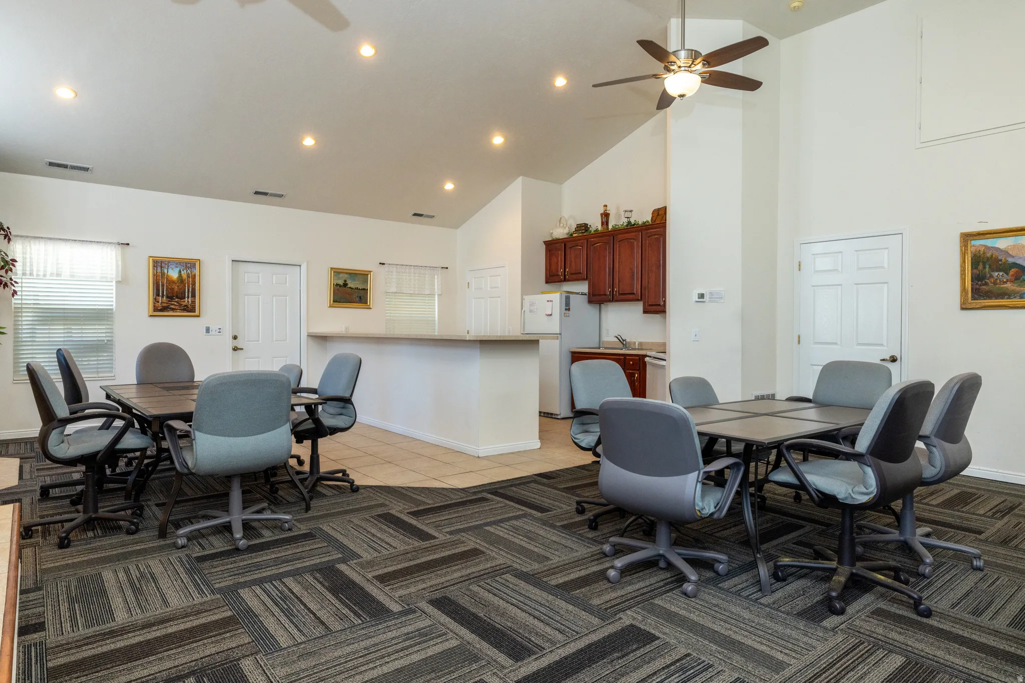 Dining area with a ceiling fan, light tile patterned floors, recessed lighting, and lofted ceiling