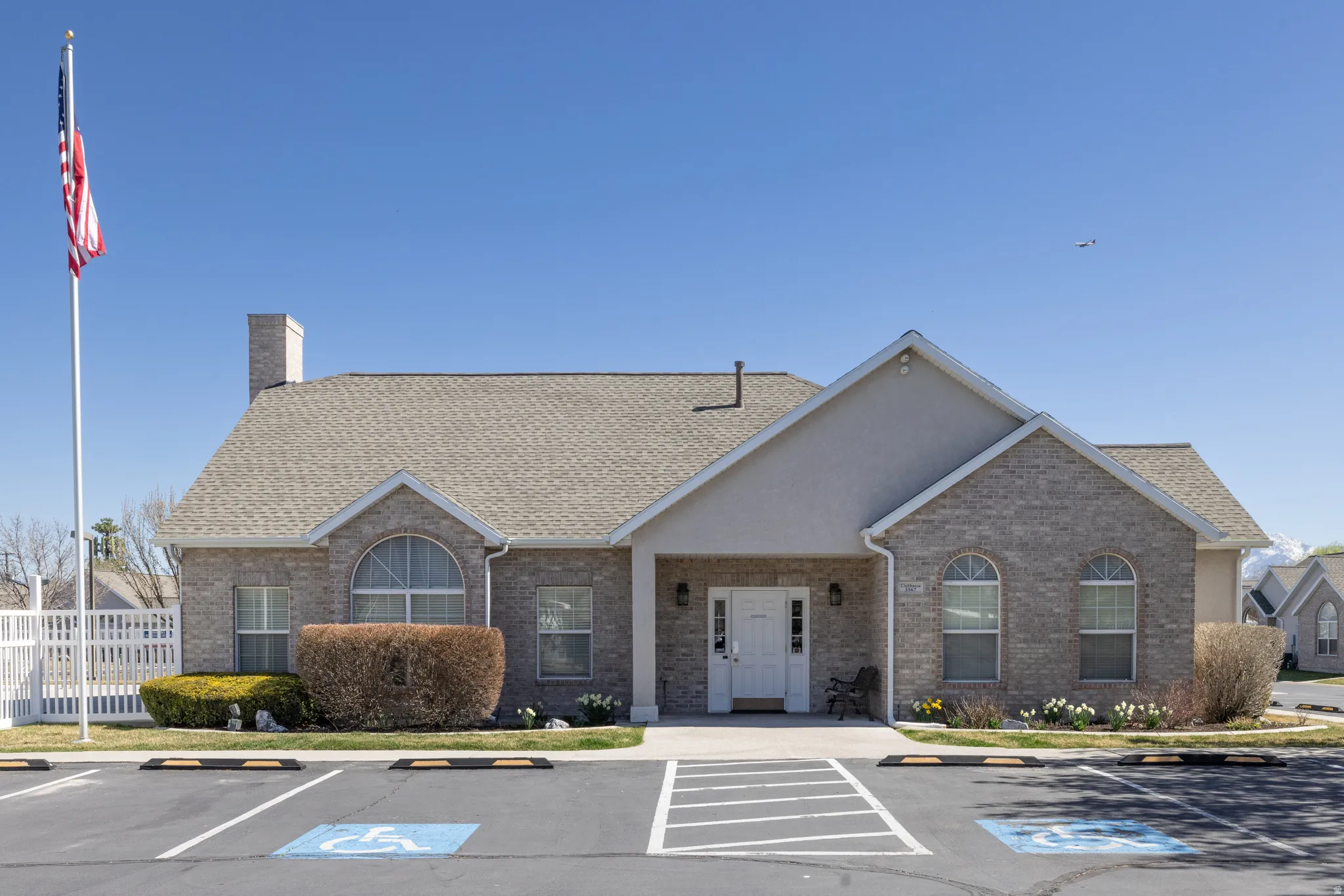 View of club house exterior featuring uncovered parking