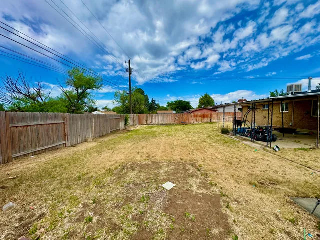 Expansive backyard featuring a partial privacy fence