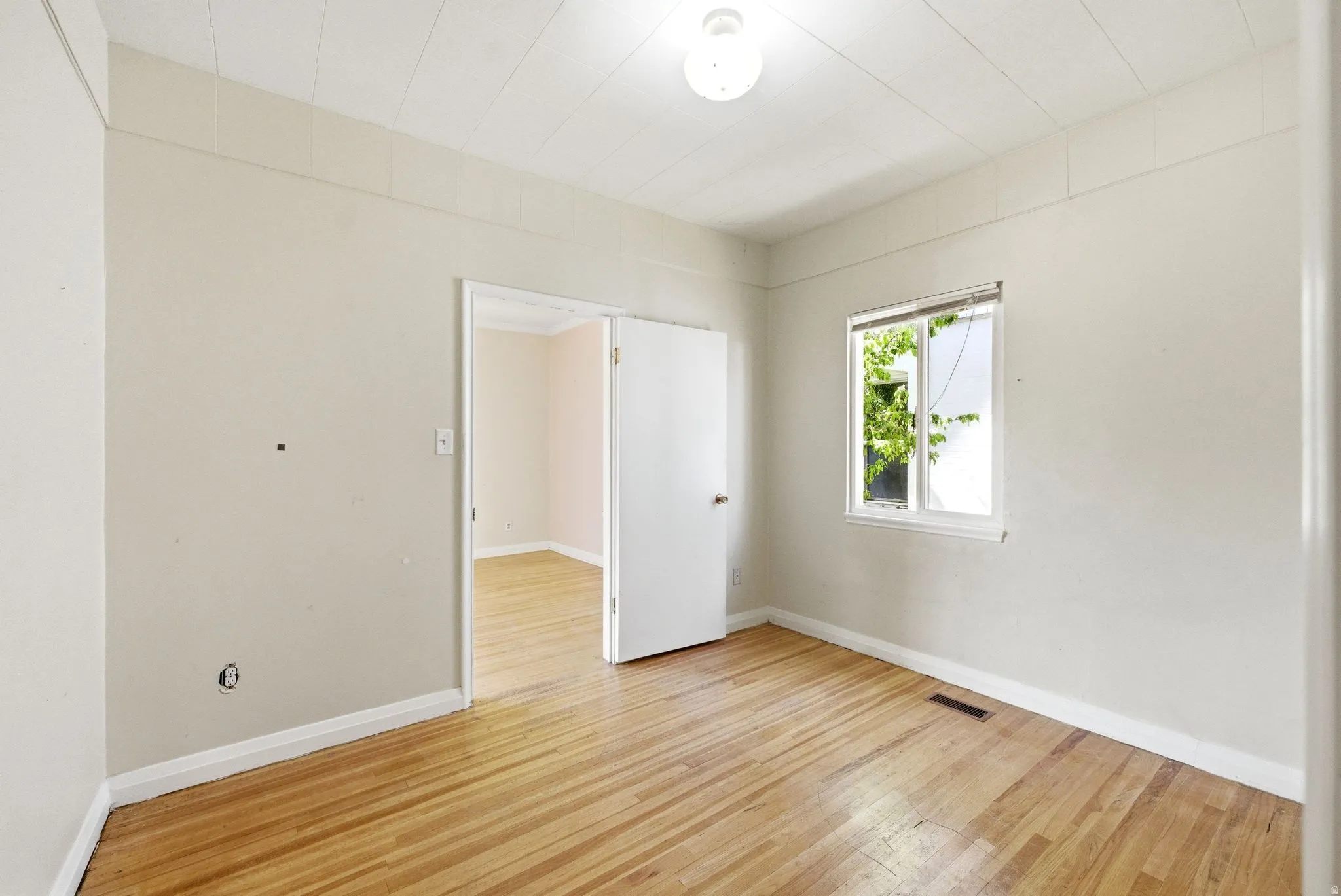 Empty room featuring light wood-type flooring and baseboards