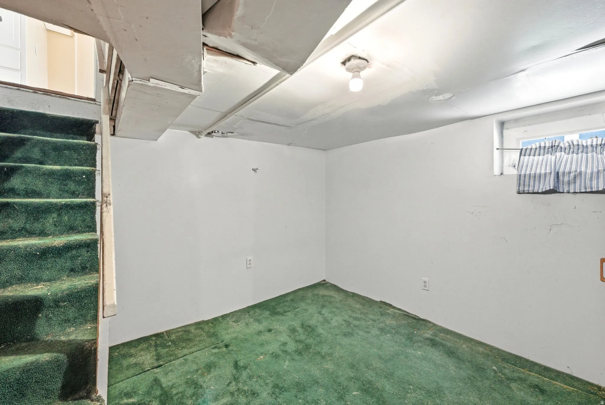 Below grade area with carpet floors and stairs