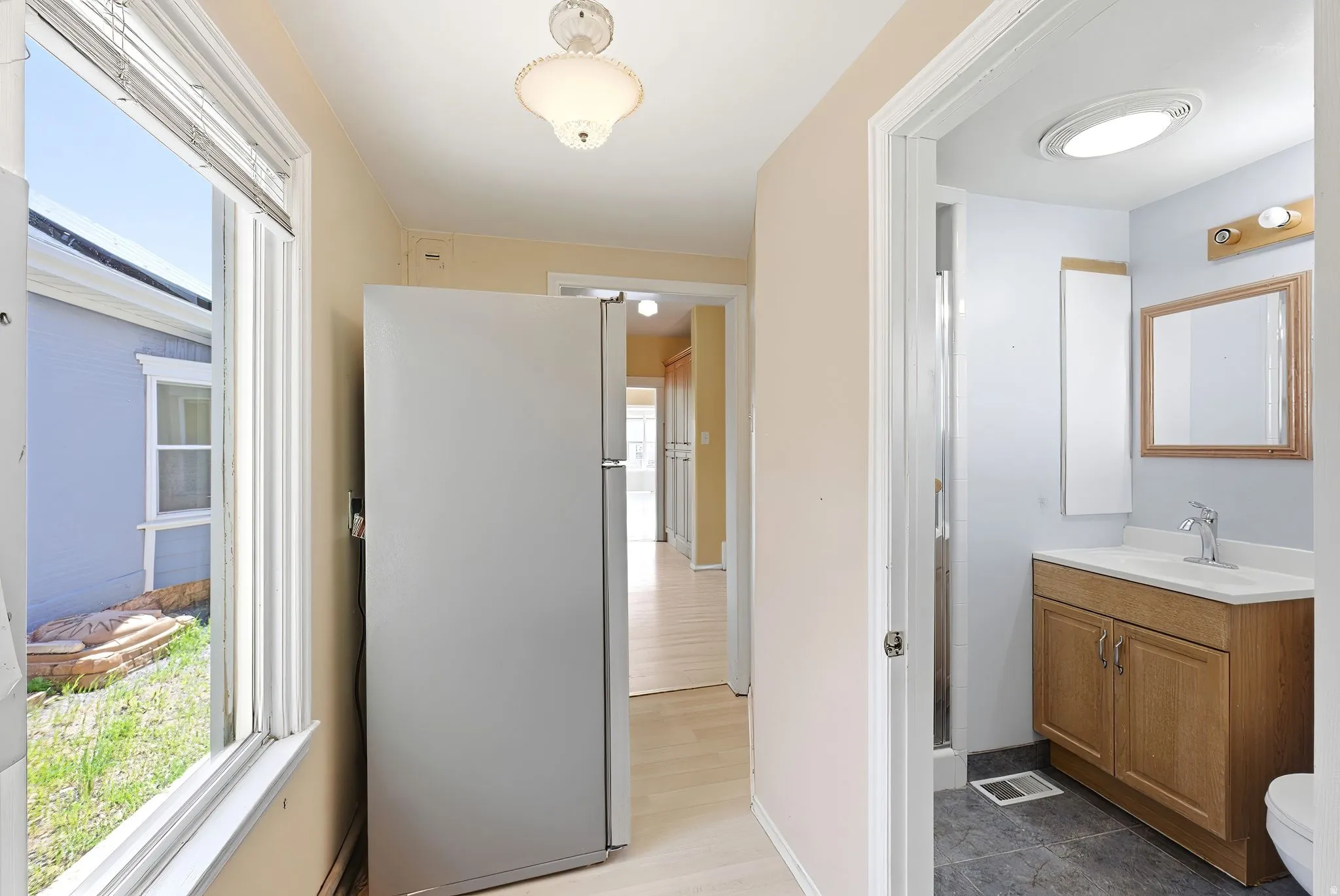 Bathroom featuring vanity and healthy amount of natural light